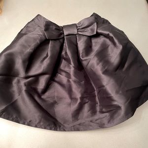 Black kick off skirt with bow detail at waistline